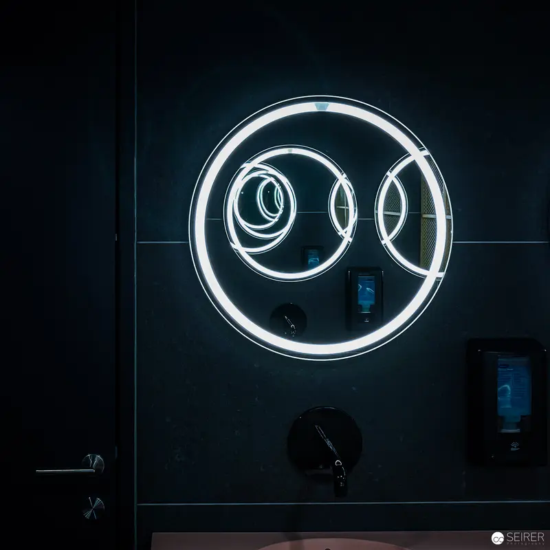 Luminescent Circular Neon Installation in Monochromatic Dark Environment