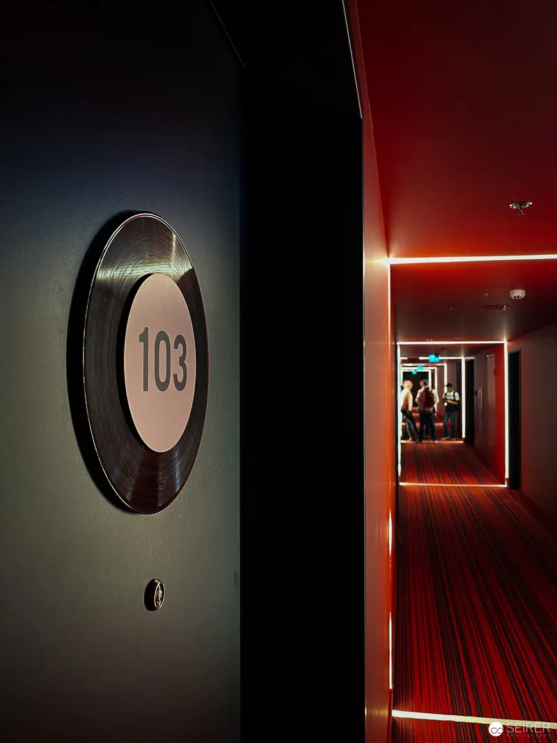 Hotel Hallway with Room 103 - Geometric Illumination and Architectural Perspective