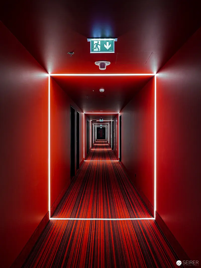 Crimson Corridor: Geometric Light Installation in Architectural Interior
