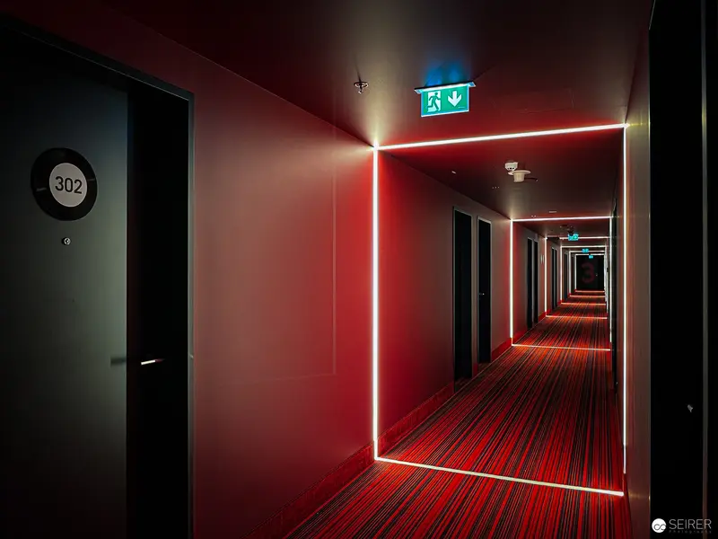 Luminous Geometric Corridor in Red and Blue Emergency Lighting Design