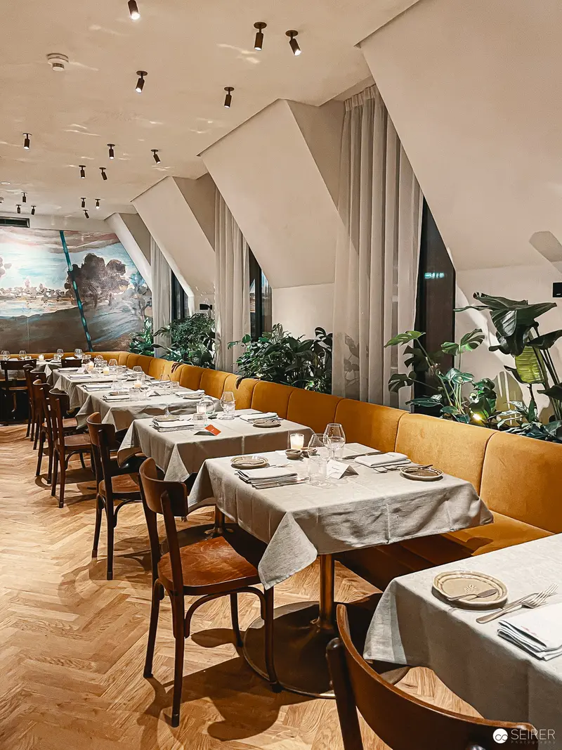 Interior of Hotel Motto, Vienna: Elegantly Appointed Dining Room with Herringbone Floors