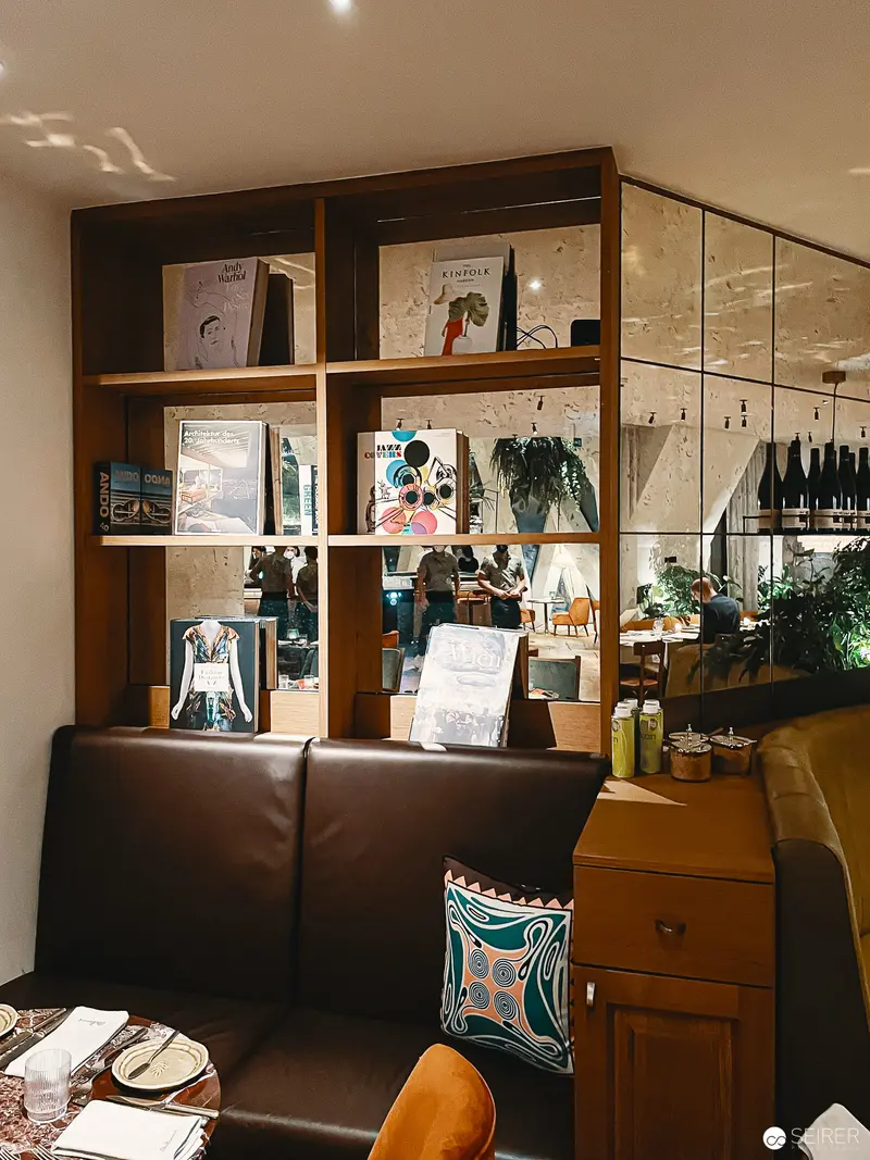 Interior Composition at Hotel Motto, Vienna: Bibliographic Display and Leather Seating