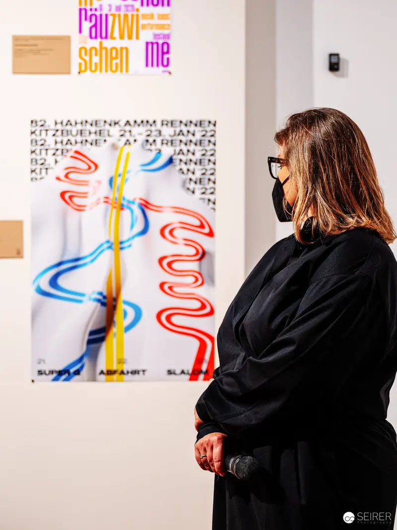 Art Historian Examining Graphic Design Poster at 100 Best Posters Exhibition