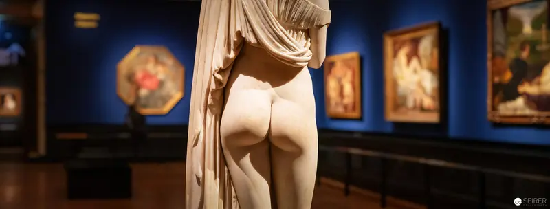 Classical Sculpture Viewed from Behind in Museum Exhibition Space