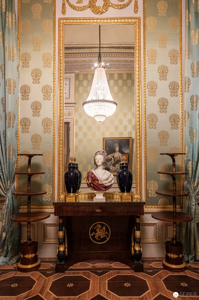 Ornate Salon Interior with Decorative Bust and Crystal Chandelier