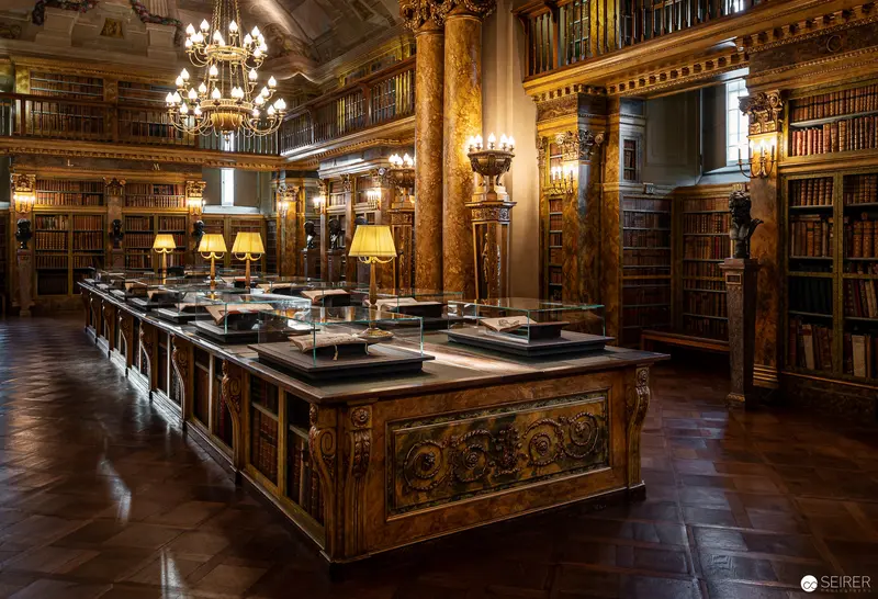 Ornate 19th-Century Library Interior with Illuminated Manuscript Display
