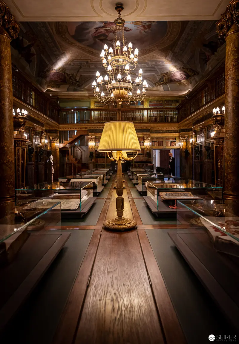 Ornate Interior with Illuminated Display Cases and Baroque Chandelier