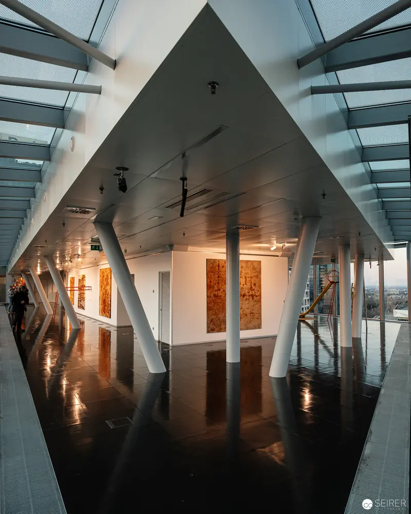 Modern Gallery Interior with Angular Architecture and Reflective Surfaces