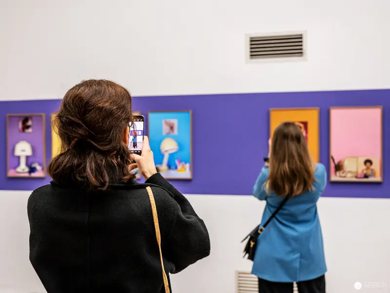 Visitors Documenting Art at FOTO WIEN 2022 Exhibition