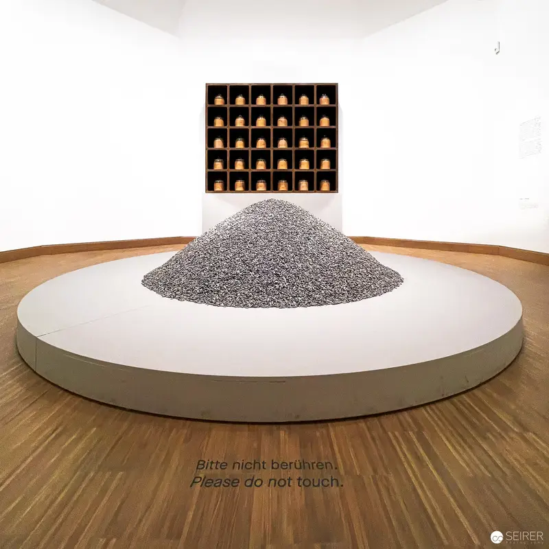 Ai Weiwei's Minimalist Installation with Gray Mound and Wooden Cubes at Albertina Modern