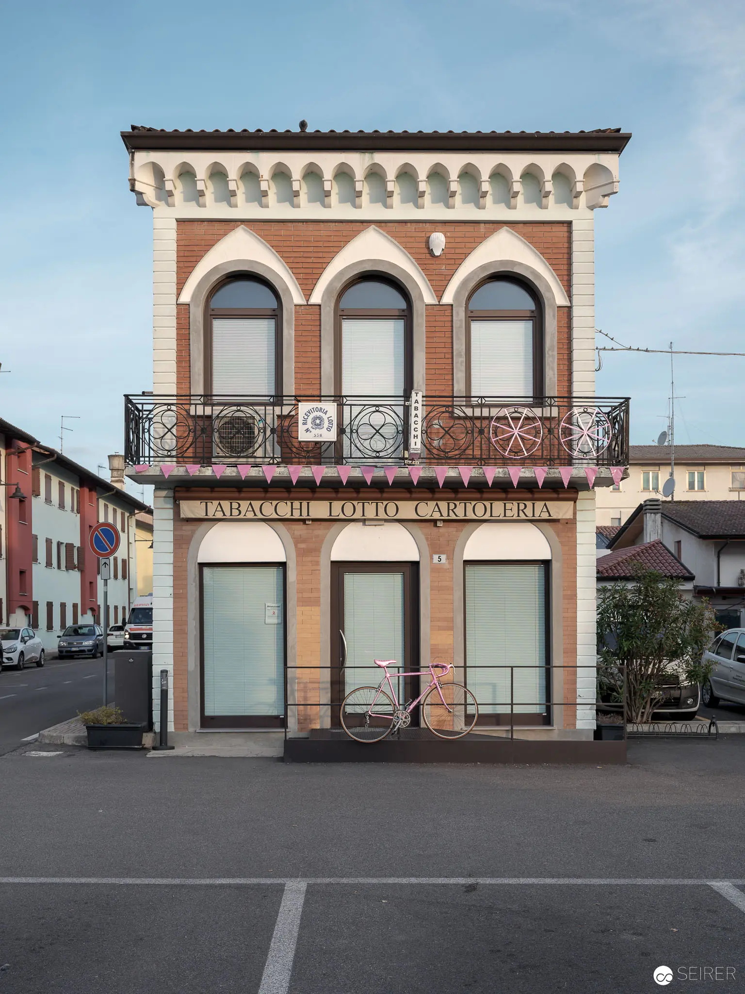 Ornate Italian Architectural Façade with Decorative Balcony in Provincial Urban Setting