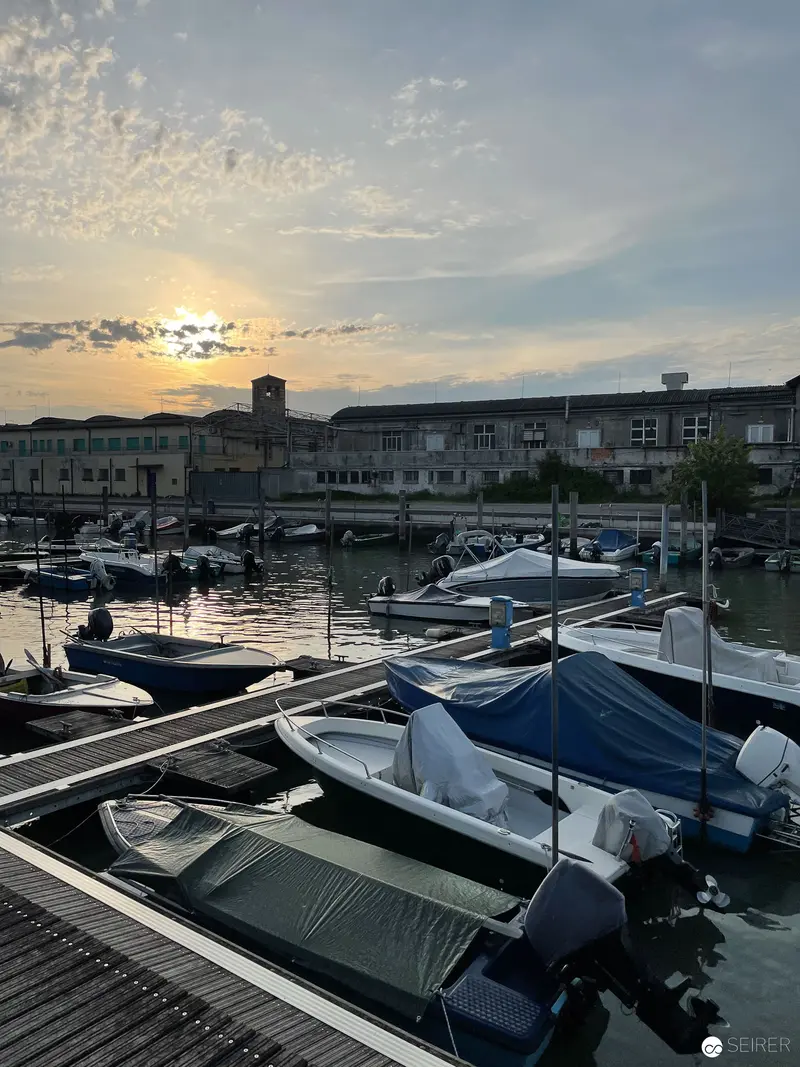 Sunset Marina with Moored Boats and Urban Landscape at Dusk