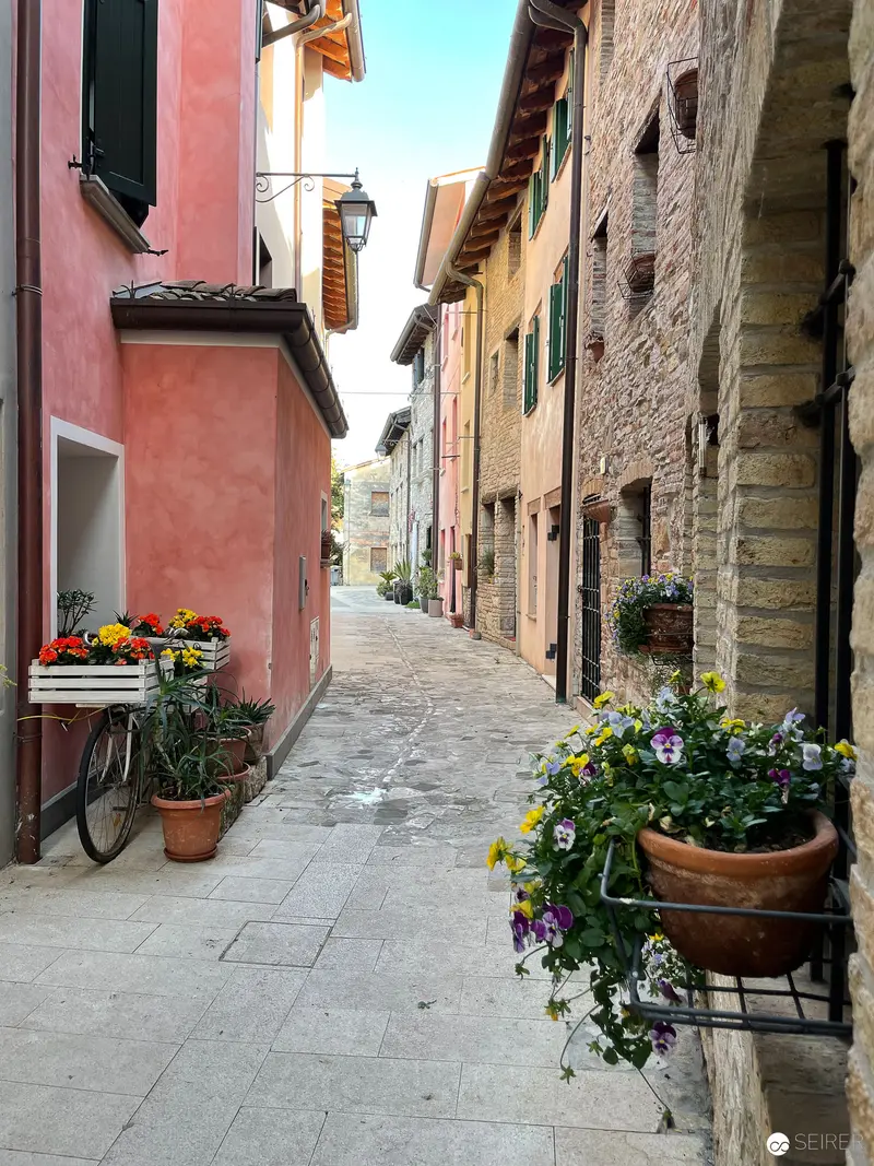 Tranquil Alleyway in Italian Village with Terracotta Architecture and Floral Arrangements