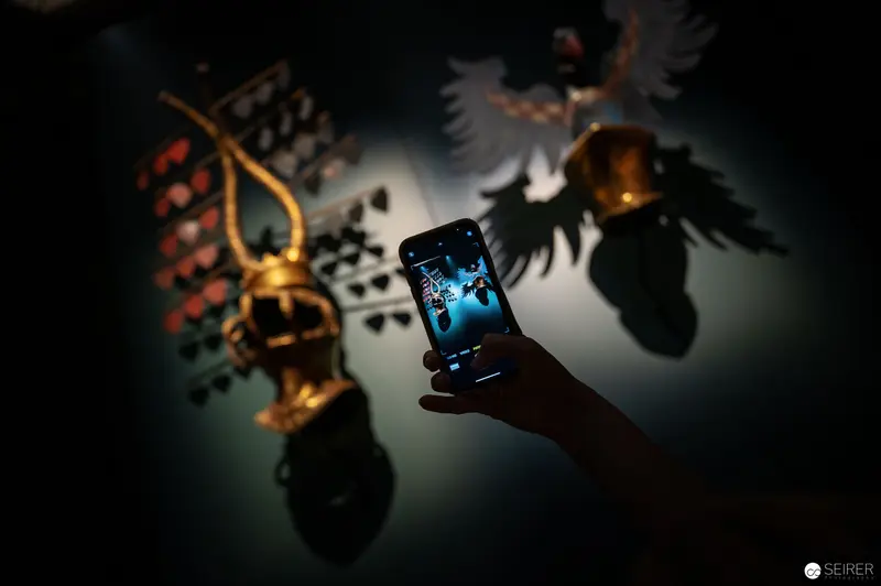 Smartphone Screen Illuminates Baroque Armor Display at "Iron Men" Exhibition