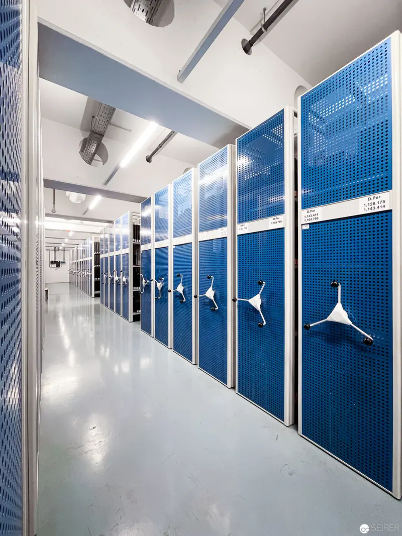 Blue Mobile Storage System in Modern Archival Space with Mechanical Lever Handles