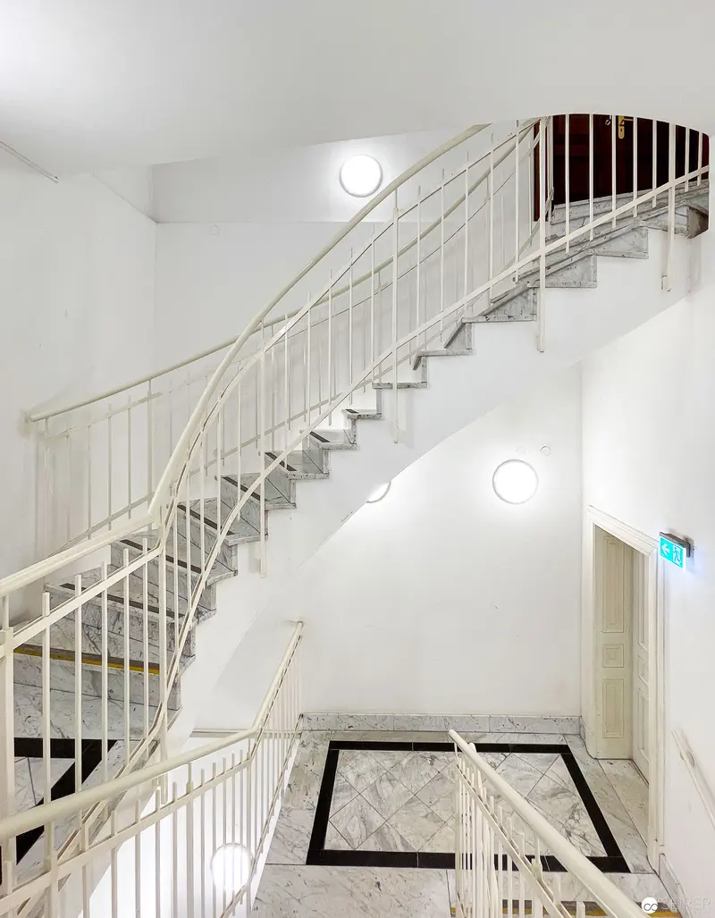 White Staircase Interior at CIM National Library Vienna with Geometric Floor Pattern