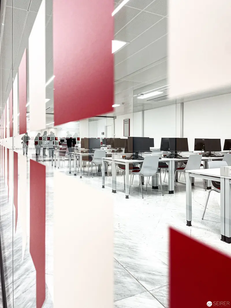 Modern Media Workspace with Red Architectural Panels at CIM Vienna National Library