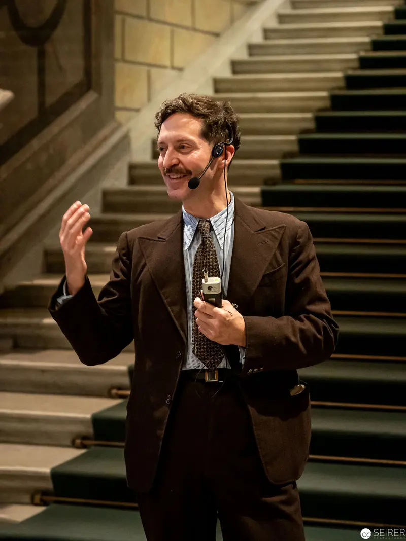 Spirited Presenter Gesturing During Exhibition at Kunsthistorisches Museum Wien