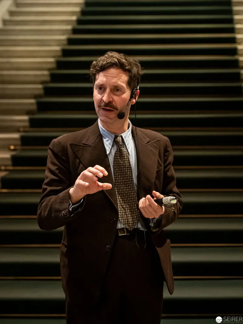 Mid-Century Professional Demonstrating Gesture in Stairwell Setting