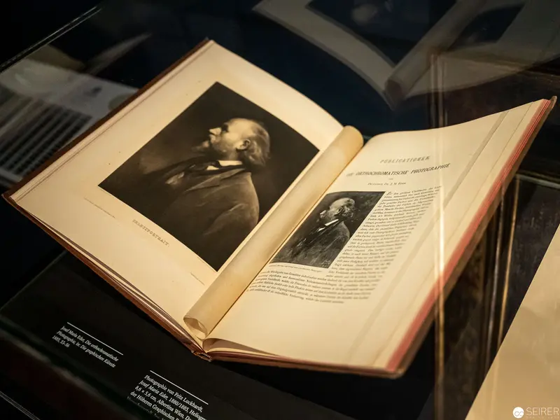 Open Book Displaying Black and White Portrait in Historical Exhibition