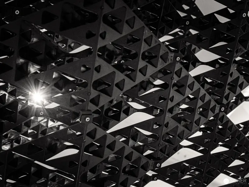 Geometric Light: Triangular Architectural Lattice with Luminous Burst