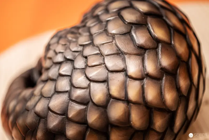 Intricate Organic Texture: Geometric Scale-Like Surface in Metallic Bronze Tones