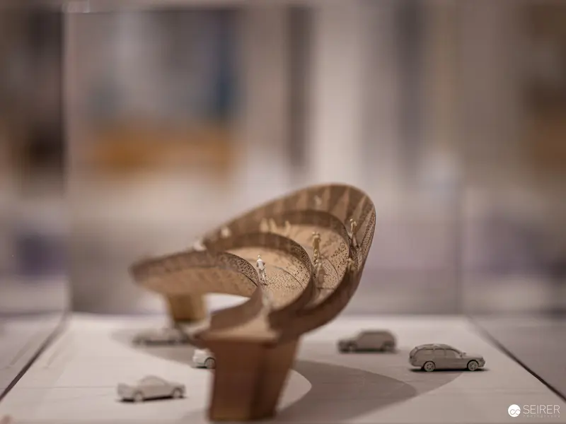 Miniature Urban Landscape with Curved Architectural Model and Tiny Vehicles