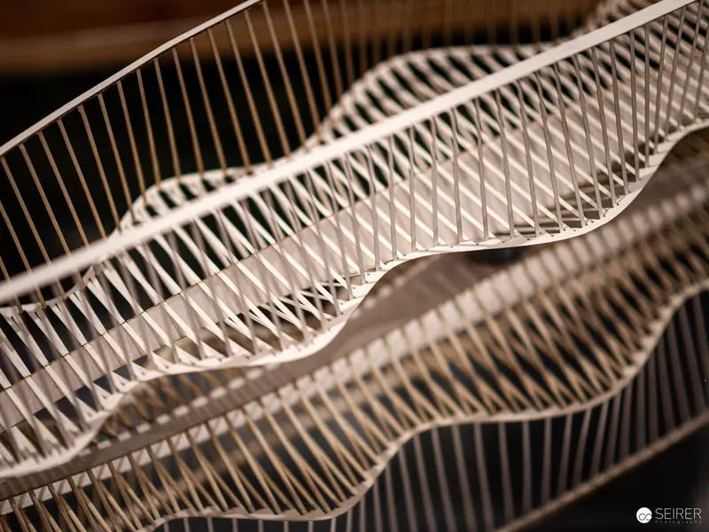 Intricately Woven Wire Mesh Sculpture Displaying Undulating Geometric Wave Patterns