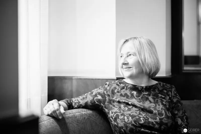 Ute Krause in Contemplative Moment During Interview with Janett Cernohuby