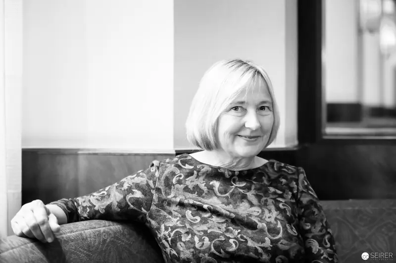 Ute Krause in Reflective Pose During Interview with Janett Cernohuby