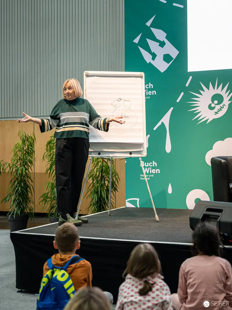 Buch Wien 2022: Speaker Presenting at Literary Event on Raised Stage