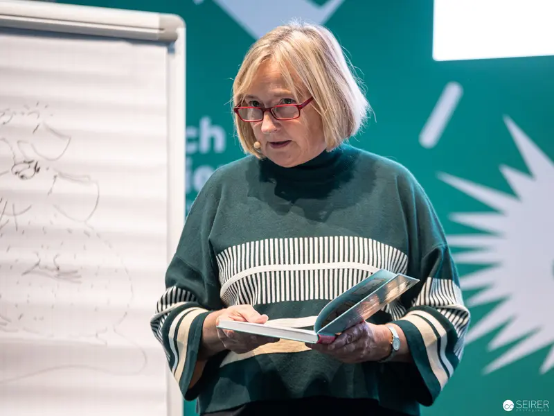 Book Wien 2022: Author Reading with Glasses and Striped Sweater