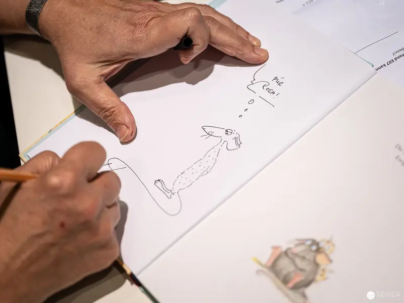 Close-Up of Hands Sketching Detailed Technical Drawing at Book Wien 2022