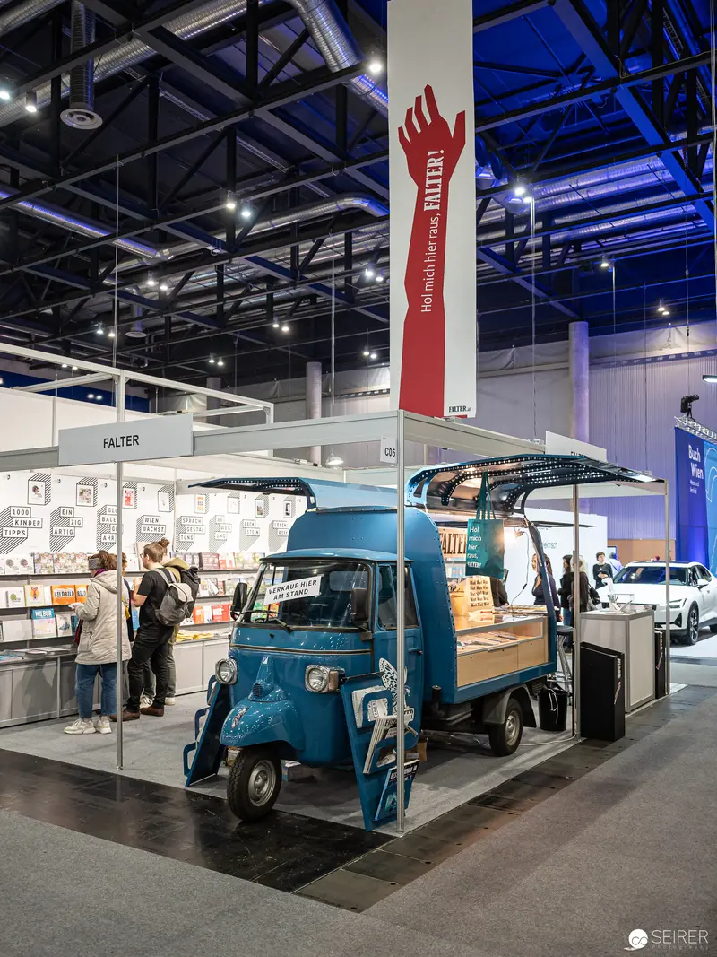 Blue Vintage Piaggio Ape Three-Wheeler at Buch Wien 2022 Exhibition Stand