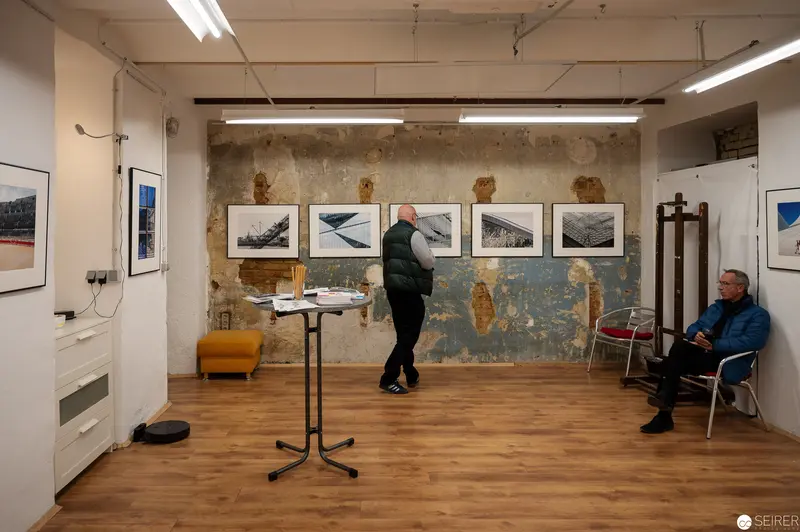 Contemporary Art Gallery Interior with Visitors Examining Photographic Exhibition