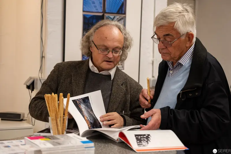 Two Scholars Examining Photographic Publication in Intimate Study Session
