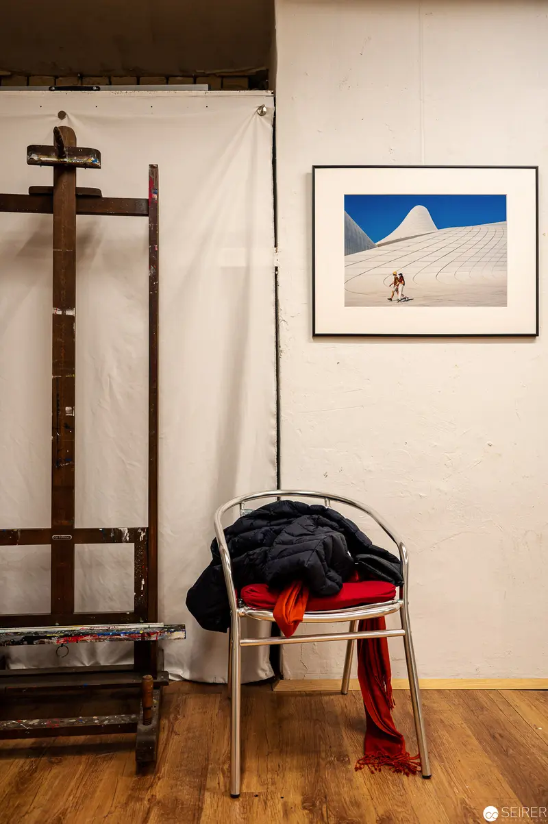 Studio Interior with Photographic Artwork and Draped Clothing on Chair