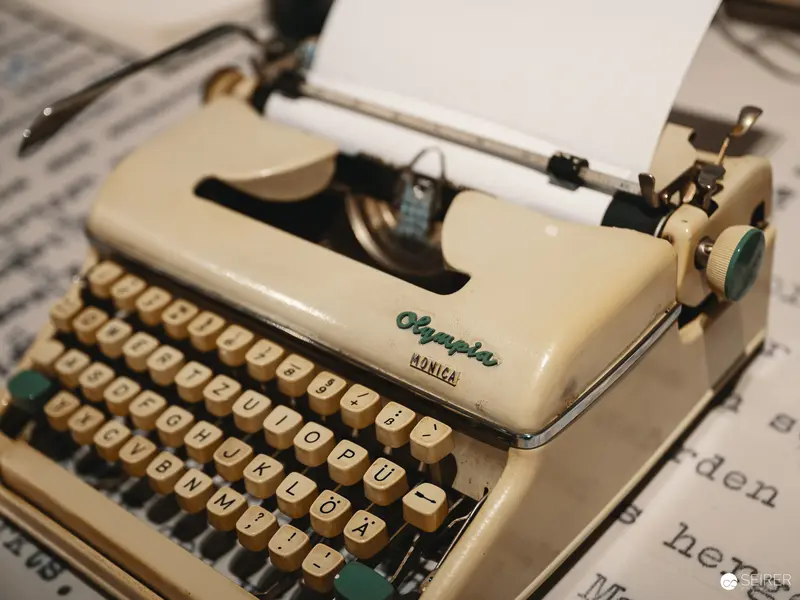 Vintage Olympia Typewriter with Blank Paper, Nostalgic Writing Instrument