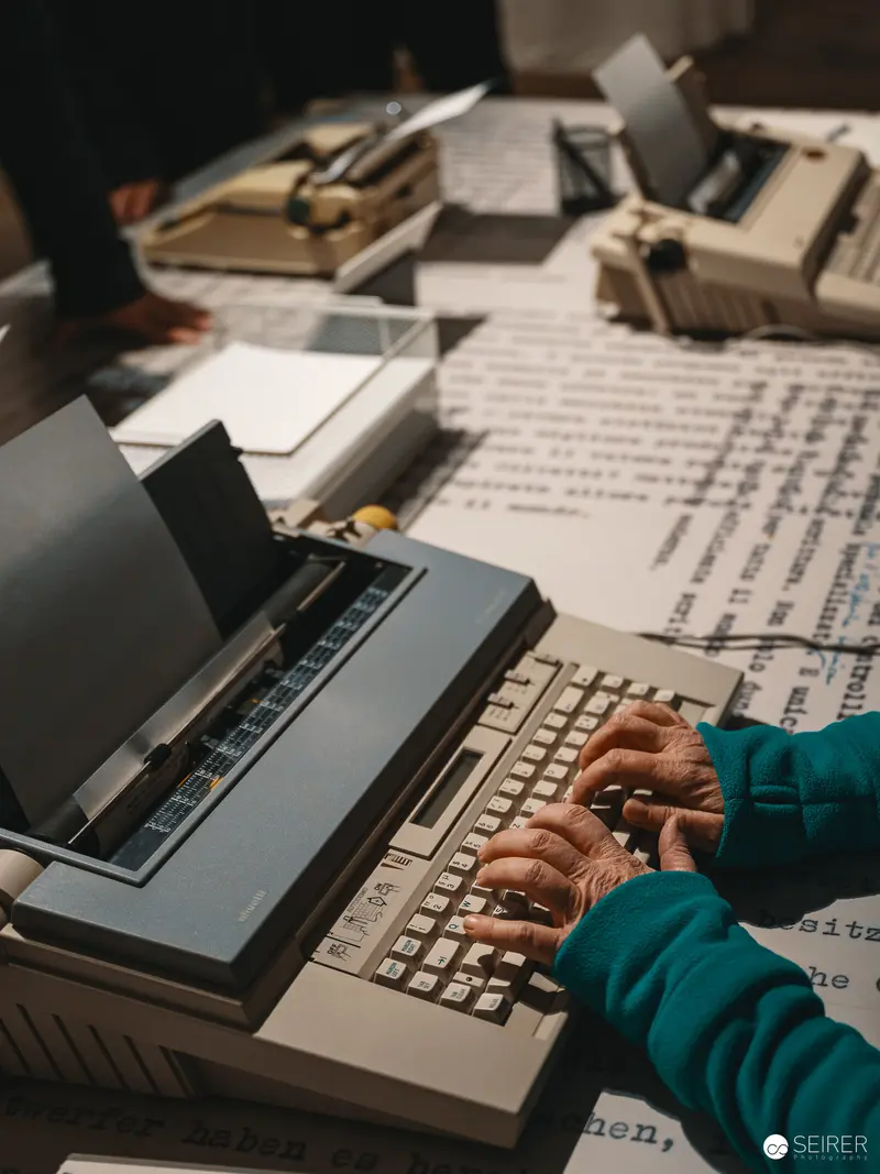 Typing Hands on Vintage Typewriter during Literary Documentation