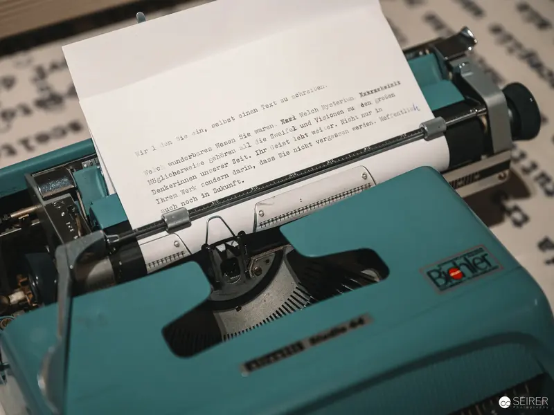 Vintage Turquoise Typewriter with Partially Typed Manuscript Page