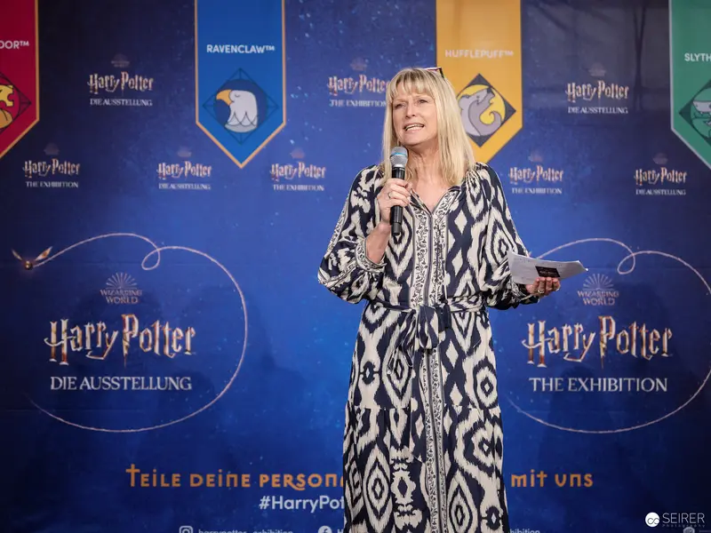 Blonde Speaker at Harry Potter Exhibition in Vienna, Presenting on Stage