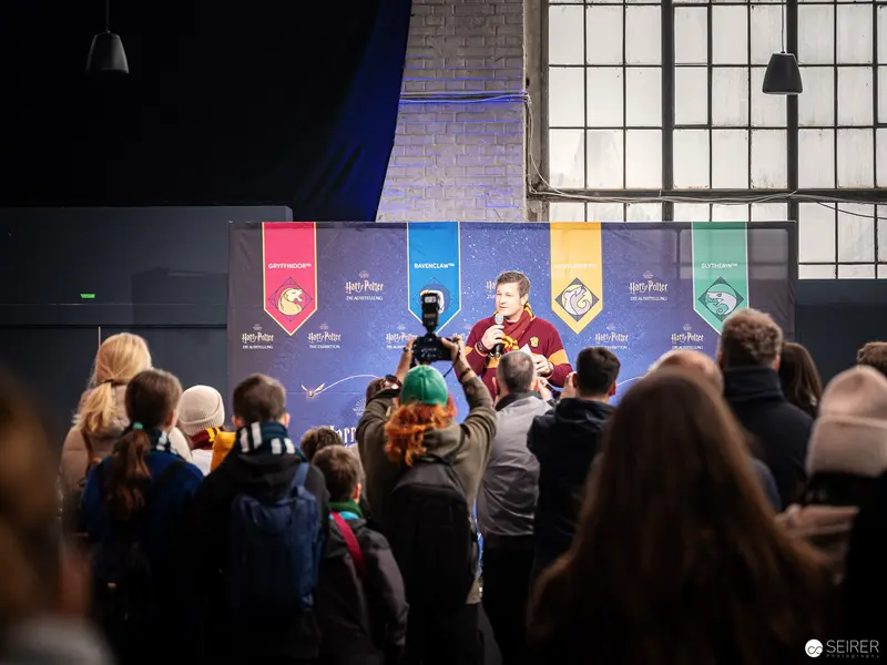 Harry Potter Exhibition Vienna: Fans Gathered Before Multicolored Branded Banners