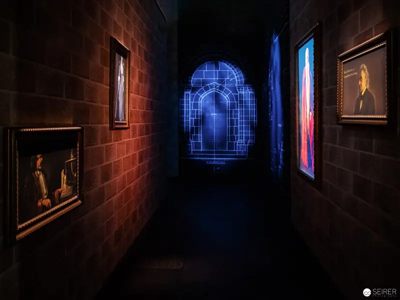 Harry Potter Exhibition Vienna: Mystical Corridor with Illuminated Artworks and Architectural Portal
