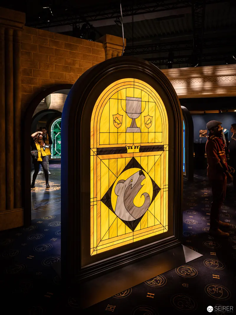 Illuminated Hogwarts Stained Glass Window Featuring Serpent Heraldry at Harry Potter Exhibition