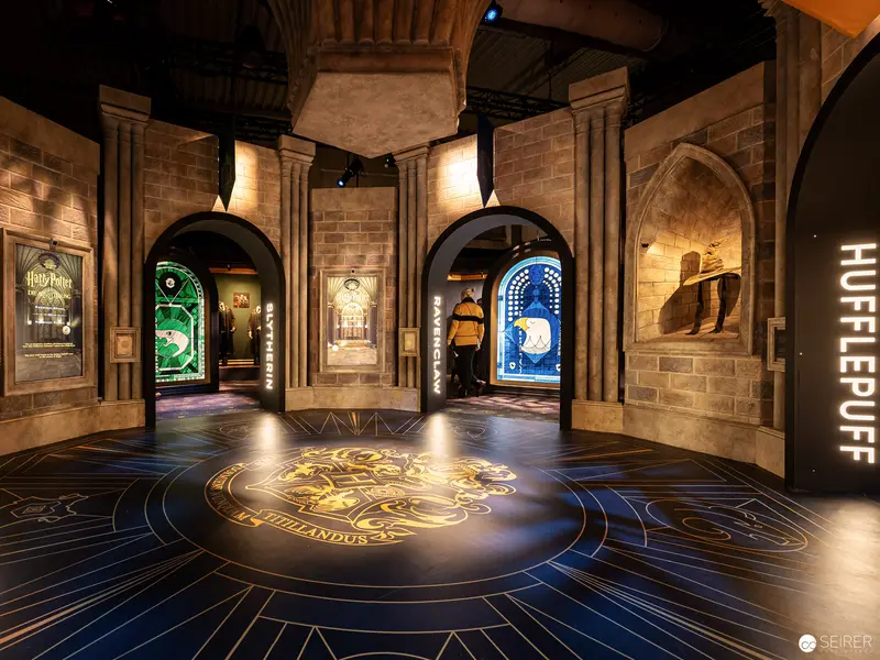 Harry Potter Exhibition Interior: Illuminated Hogwarts House Emblem at Vienna Venue