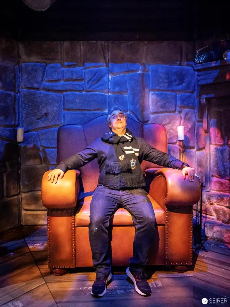 Harry Potter Exhibition Vienna: Wizard Seated on Enchanted Armchair in Magical Setting