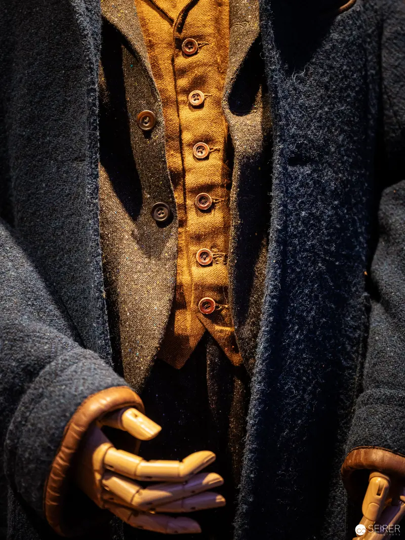 Detailed Vintage Costume Study with Textured Woolen Layers and Brass Buttons