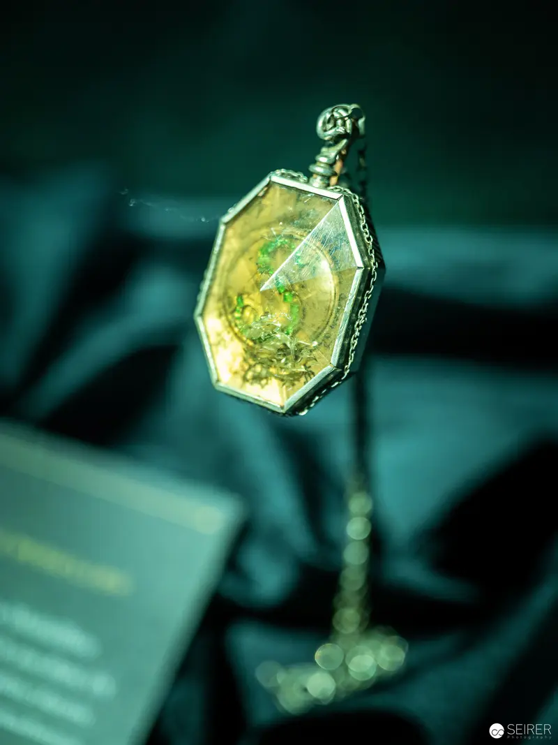 Locket with Intricate Yellow-Green Inclusion Suspended in Emerald Atmosphere