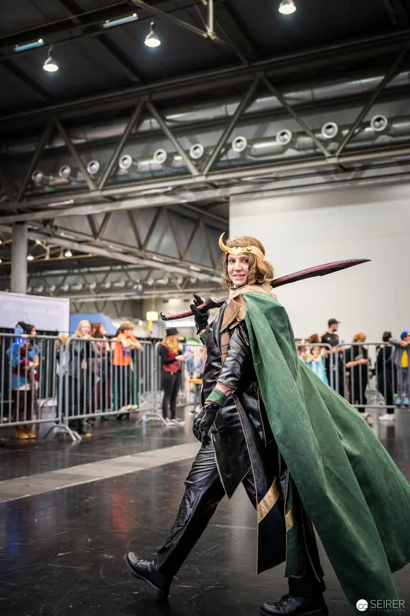 Cosplayer in Green Cape Performing at Vienna ComicCon 2022