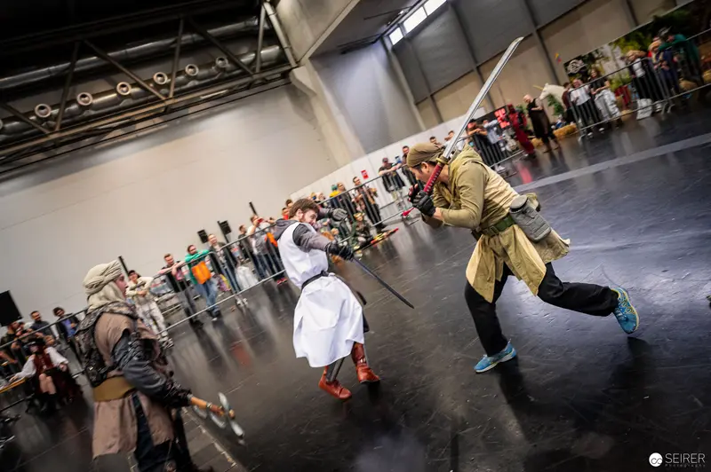 Combatants Engaged in Dynamic Sword Performance at Vienna ComicCon 2022
